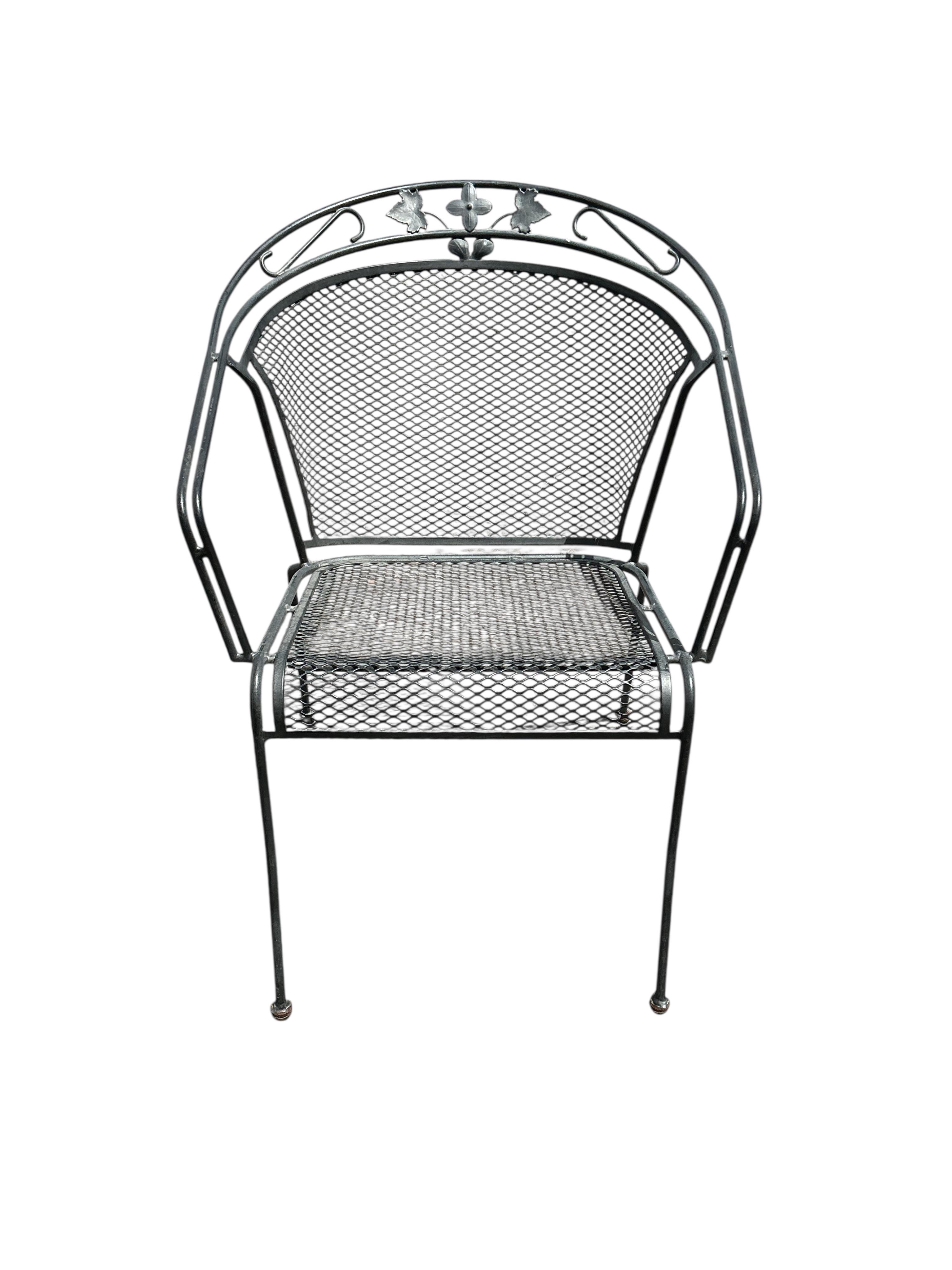 A wrought iron garden bench and ten matching garden chairs